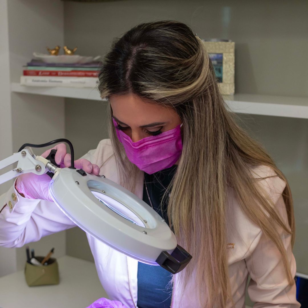 Detalhe de avaliação clínica da pele com lupa de aumento